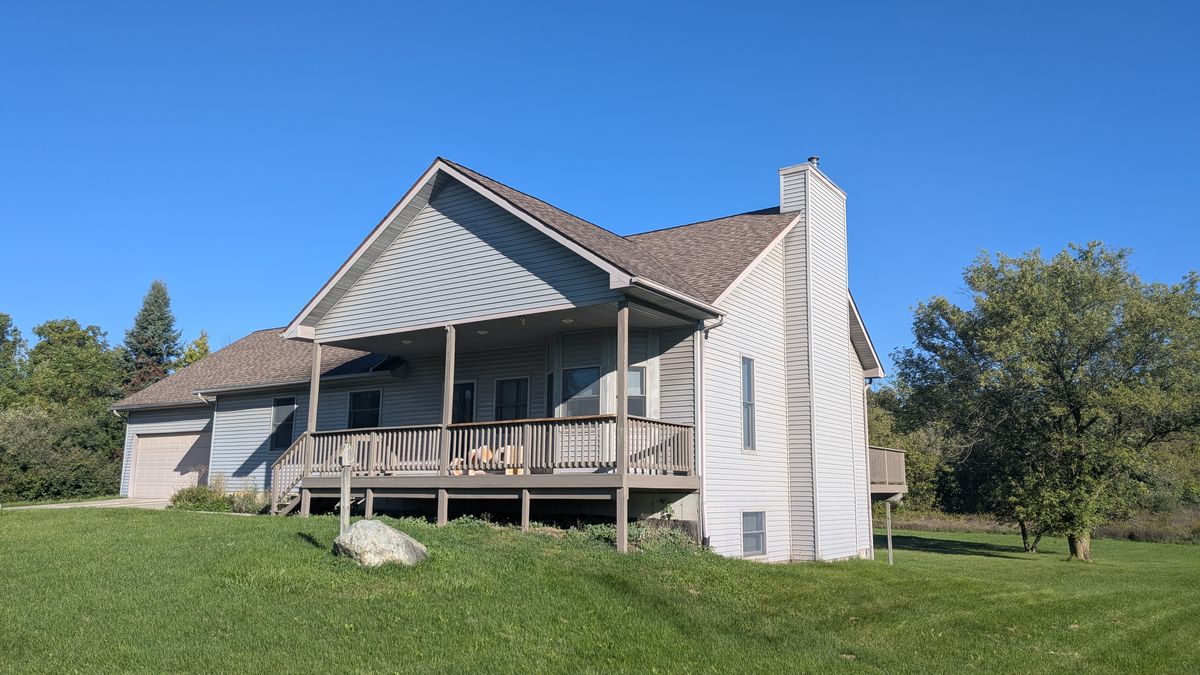Front corner of the house showing the porch and the chimney on the side wall