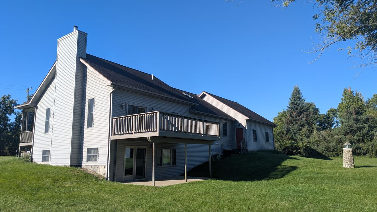 Back corner of the house with the raised deck and the chimney