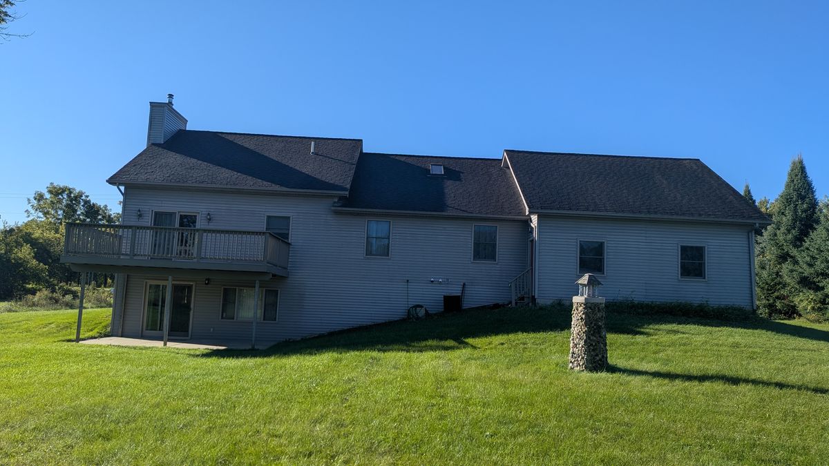 Back of the house: the yard slopes down to a walkout basement under the deck